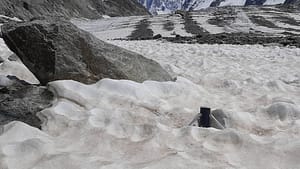 Glacier melting station SmartStake emerging from the snow in the spring
